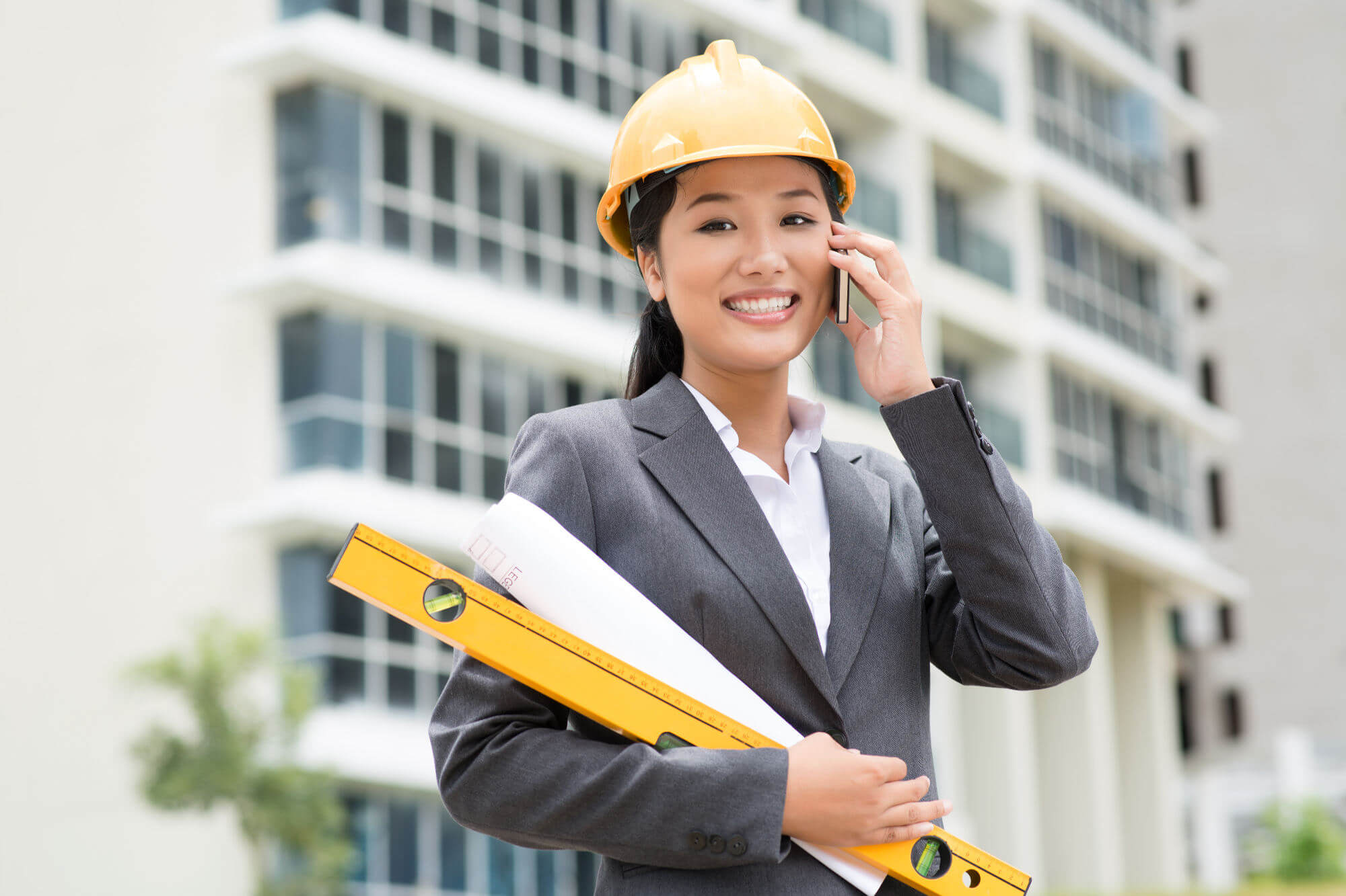 Female engineer consulting by phone from a construction site